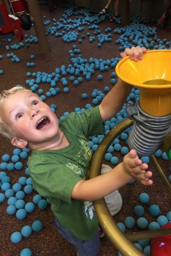 little boy playing with balls