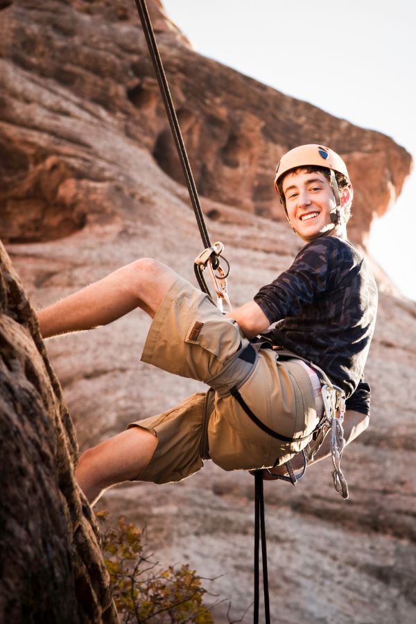 boy rock climbing